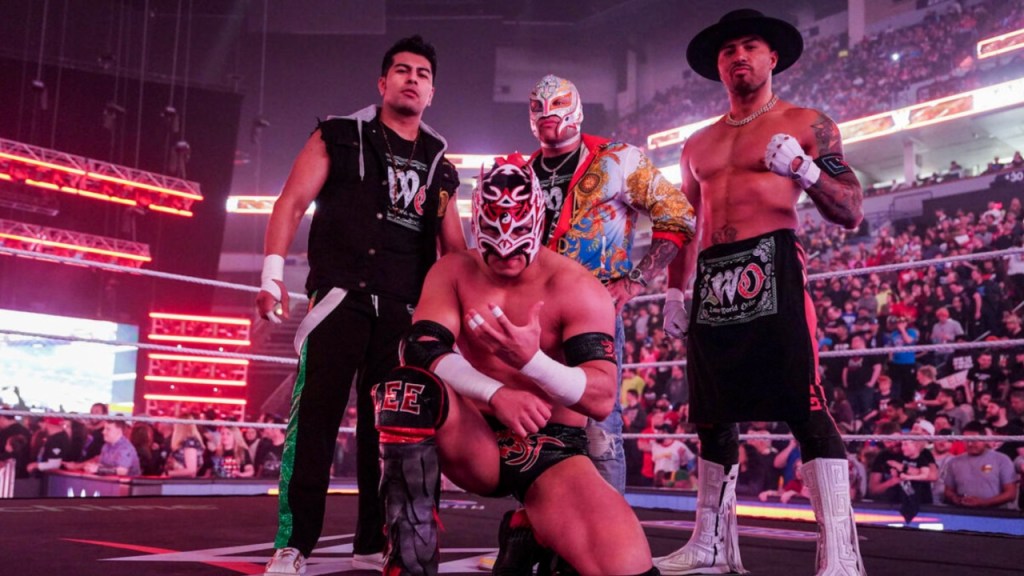 Joaquin Wilde (right) poses with the lWO before their match against American Made and El Grande Americano on WWE RAW.