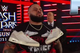 Bronson Reed with Roman Reigns' sneakers on his neck at WWE RAW